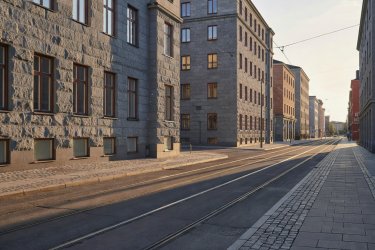 Granite architecture and tram tracks in Kallio Helsinki during afternoon light