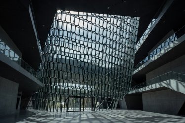 Dramatic geometric glass facade and geometric hall interior of Harpa in Reykjavik